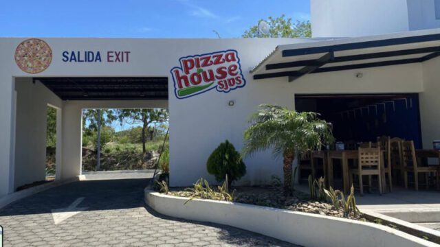 Freshly baked pizzas and cozy dining ambiance at Pizza House SJDS, located in the heart of San Juan del Sur, Nicaragua