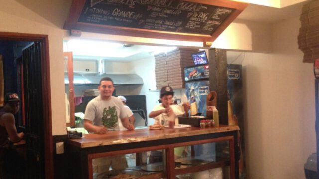Freshly baked pizza slices at Don Monchis Pizzería in San Juan del Sur, Nicaragua