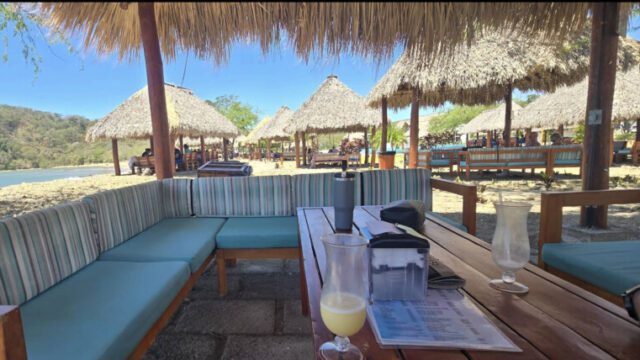Aquaholic Beach Bar's open-air seating with ocean views and tropical ambiance in San Juan del Sur, Nicaragua