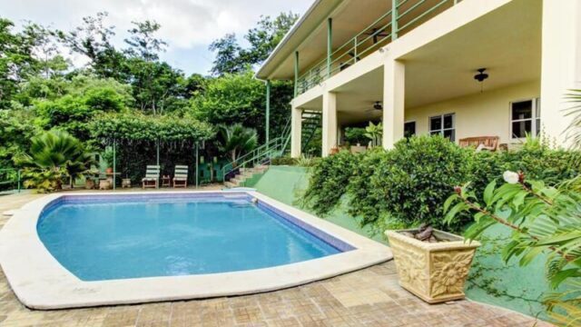 Exterior view of Green Acres Hewitt Home & Guest House surrounded by lush greenery in Hewitt, Texas