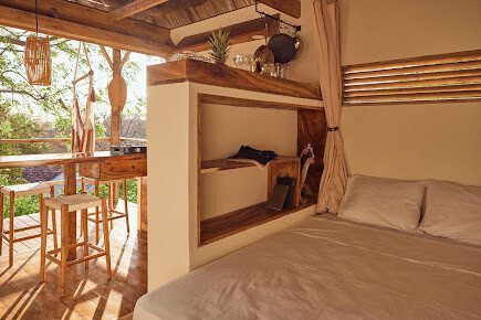 Hostel Clandestino vibrant exterior with tropical murals, lush greenery, and relaxed communal space in San Juan del Sur