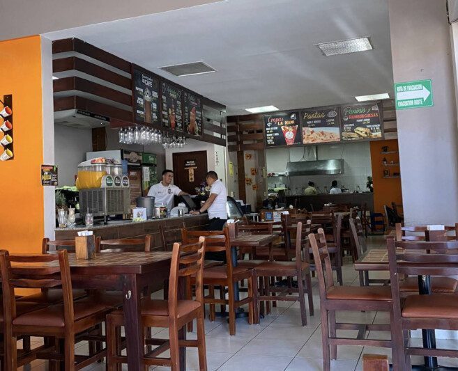 Cozy interior of La Nani Café in Masaya with guests enjoying coffee and smoothies in an air-conditioned space
