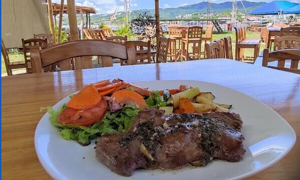 Open-air dining at Rompeolas in San Juan del Sur, Nicaragua. Image of food and a view.