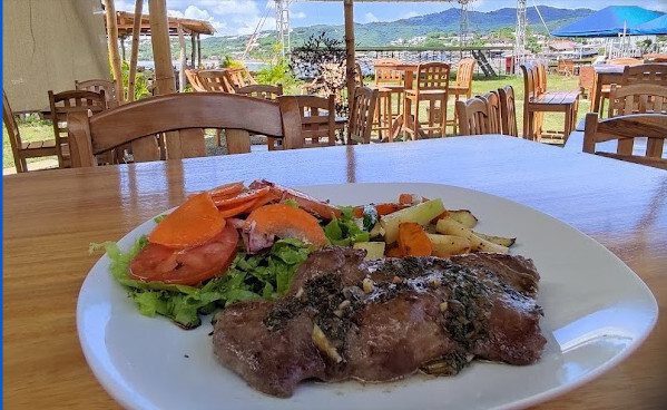 Open-air dining at Rompeolas in San Juan del Sur, Nicaragua. Image of food and a view.