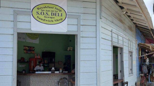 Exterior view of SOS Deli in San Juan del Sur, showcasing its inviting entrance and signage