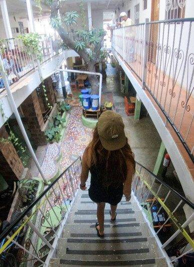 Interior of Café Oro in San Juan del Sur featuring eco-friendly design with reclaimed materials and recycled glass bottle walls.
