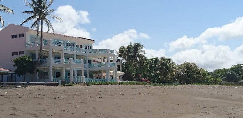Exterior view of Hola Ola Hostel with pool and communal area in San Juan del Sur, Nicaragua