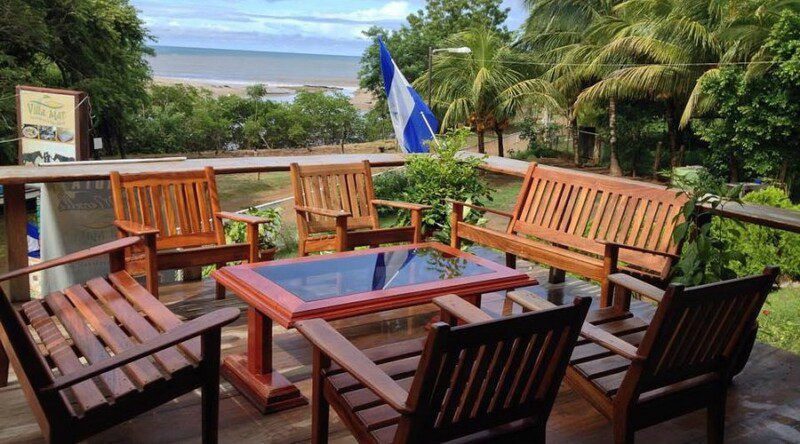 Hostal and Restaurant at Villa Mar exterior view with beachfront setting, colorful facade, and shaded outdoor dining area in San Juan del Sur