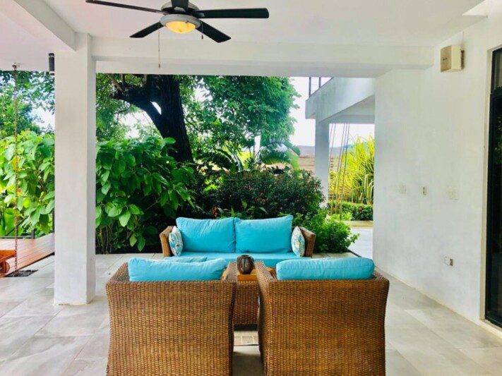 View of Villa Escondida through a covered area to green views beyond – Luxury villa with panoramic bay views in San Juan del Sur, Nicaragua