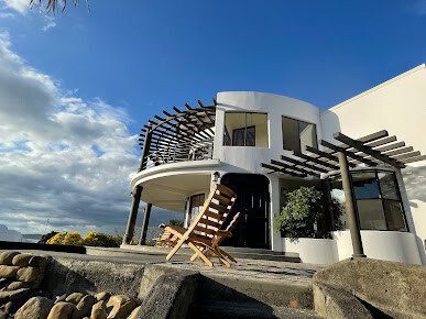 Apogeo Guest House's lighthouse-inspired structure with ocean view pool in San Juan del Sur, Nicaragua