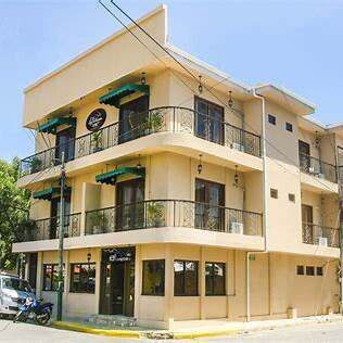 View of Hotel La Estación façade with balconies and colonial charm, located near the beach in San Juan del Sur
