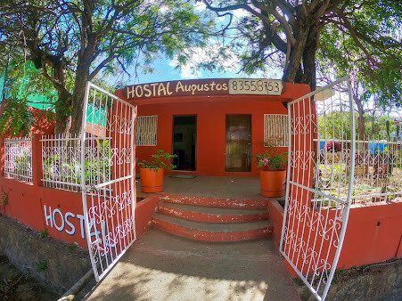 Hostal Augustos' tranquil garden area with outdoor seating in San Juan del Sur, Nicaragua