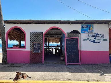 Outdoor seating area of Isabellas Bar with ocean view in San Juan del Sur, Nicaragua