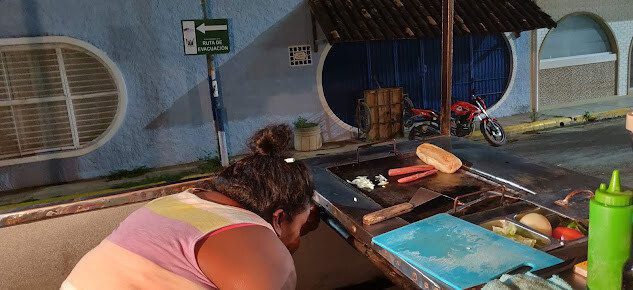 Joeli Hotdog food cart in San Juan del Sur serving gourmet hot dogs with various toppings.