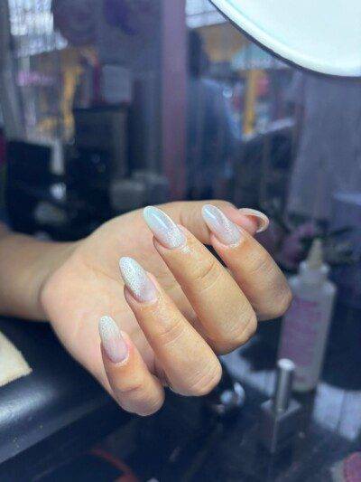 Nail Room Odaly interior showing manicure table, organized nail polish display, and cozy seating in a relaxing nail salon setting