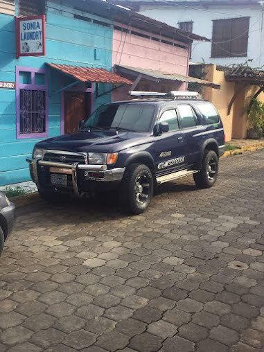 Dayanna Rent a Car & Activities white 4×4 vehicle on road in San Juan del Sur