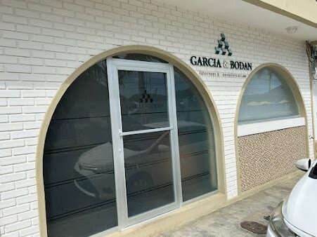 Front of Garcia and Bodan office in San Juan del Sur with law firm signage next to Hotel Alcázar