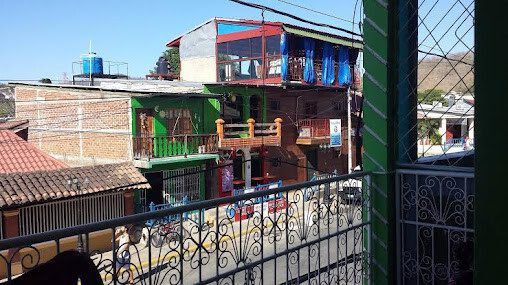 Exterior view of Hostal Mama Sara in San Juan del Sur, Nicaragua, showcasing its proximity to the beach and welcoming entrance