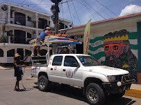 Surf coach guiding beginner surfers at Playa Maderas, Nicaragua
