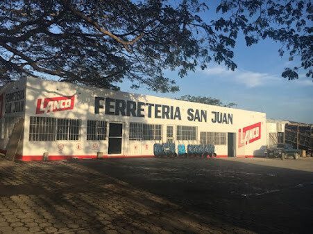Exterior of Ferretería San Juan with visible tools on display, San Juan del Sur