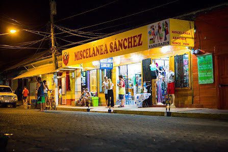 Front of Miscelania Sánchez in San Juan del Sur showing aisles with snacks, canned goods, household items, and gluten‑free products