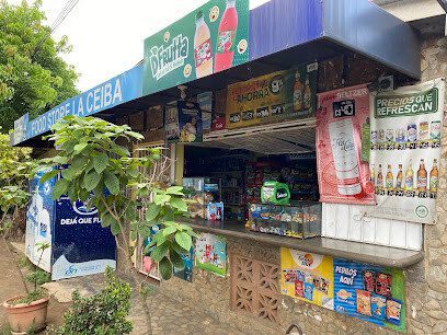 Front of La Ceiba Store in San Juan del Sur showing fresh produce display and grocery shelves inside