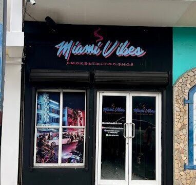 A vibrant tattoo session taking place inside Miami Vibes Smoke And Tattoo Shop in San Juan Del Sur