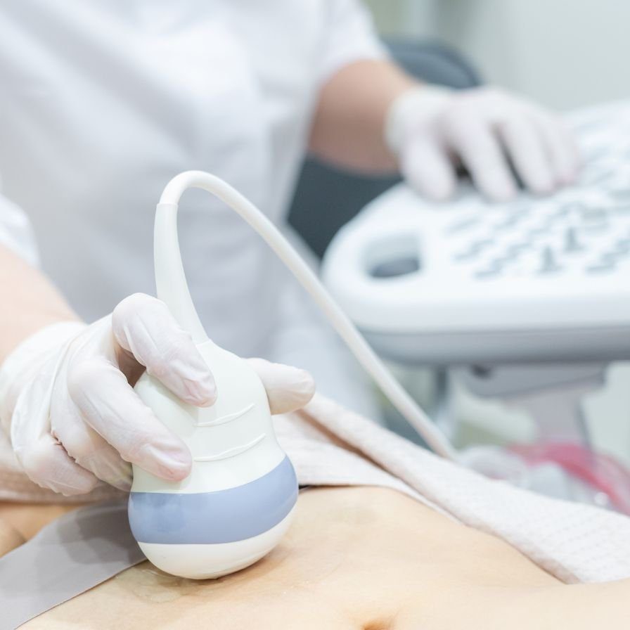 Dr Douglas Ultrasound image of an ultrasound operator doing an ultrasound on a patient's stomach