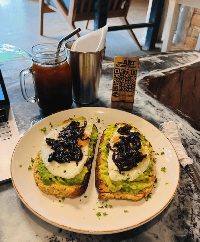 The Art Warehouse Escamequita image of a smashed avocado on toast