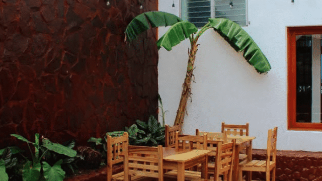 Image of outside walled area at Hotel Ocean View with tables and chairs