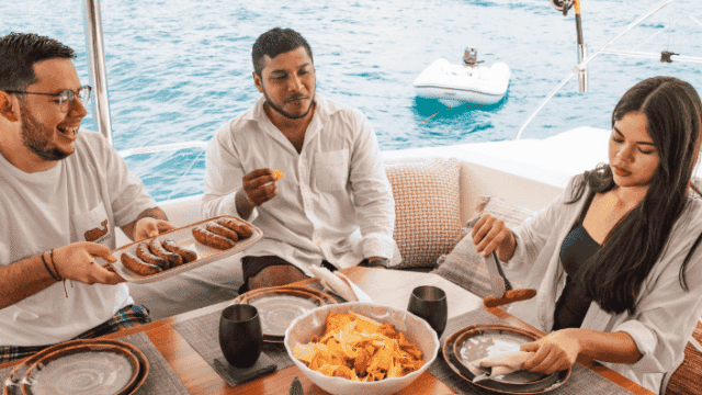 Santana Sail image of a catermaran with guests enjoying grilled meats on the ocean