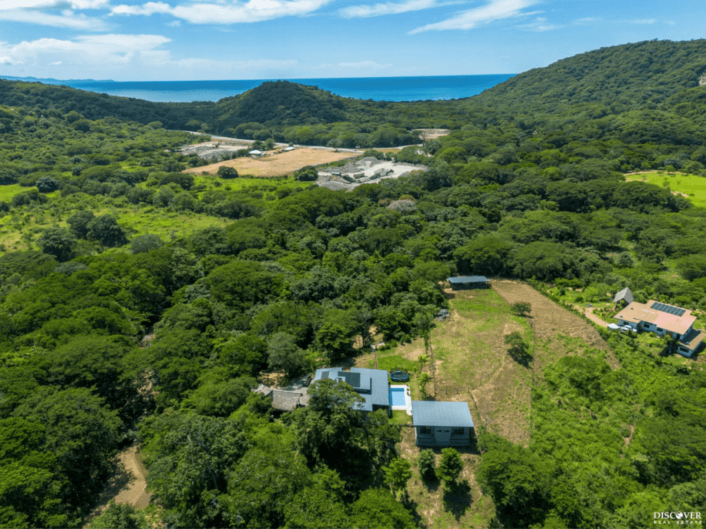 Aerial view of Kitchen at Equestrian Estate with new 3-bedroom home with 2 bedroom casita with pool and sea in background listed by Discover Real Estate