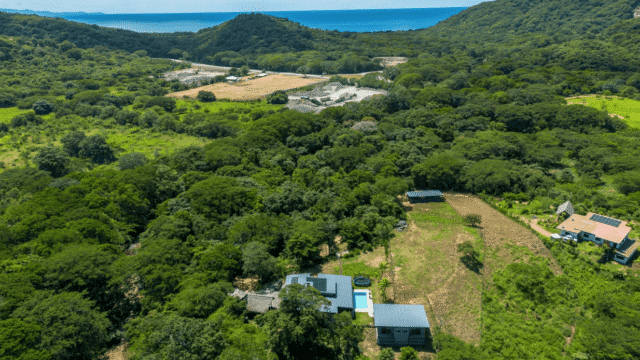 Aerial view of Kitchen at Equestrian Estate with new 3-bedroom home with 2 bedroom casita with pool and sea in background listed by Discover Real Estate