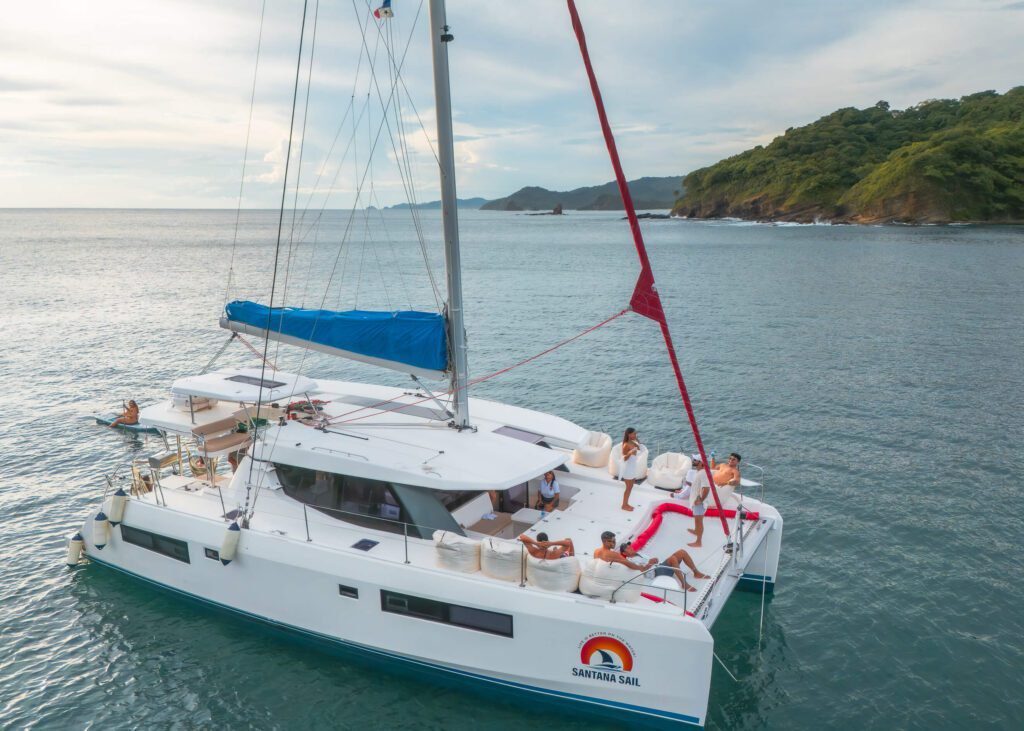 Santana Sail Nicaragua Close Up of Yacht with Santana Sail Logo and people aboard on the water