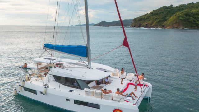 Santana Sail Nicaragua Close Up of Yacht with Santana Sail Logo and people aboard on the water