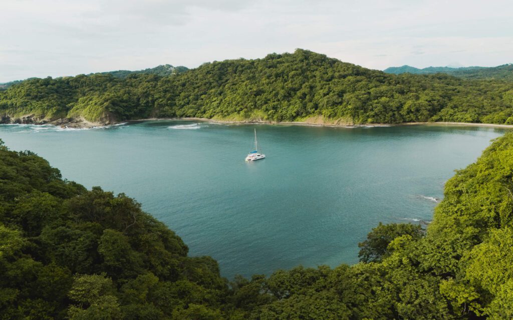 Overhead View of the Yacht from a Distance Bordered by Hills Santana Sail