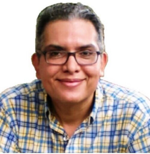 Computer and mobile phone repair technician Carlos Mora fixing laptop and phone