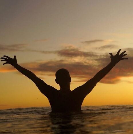 Artist Usumat Kawahe creating a mural and custom sign with paintbrush and creative tools