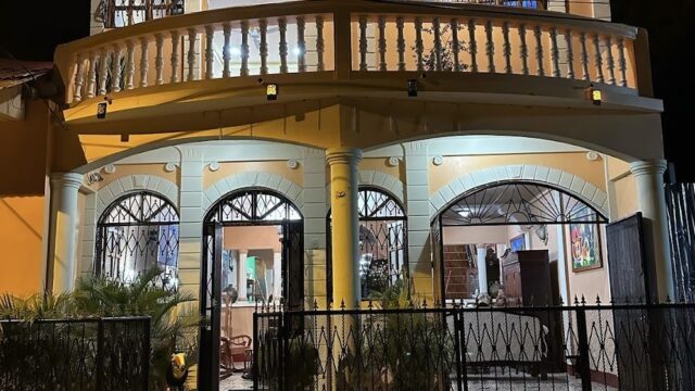 Photo of exterior of the Granados Guest House at night
